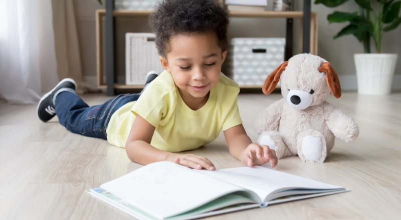 En liten pojke tittar i en bok